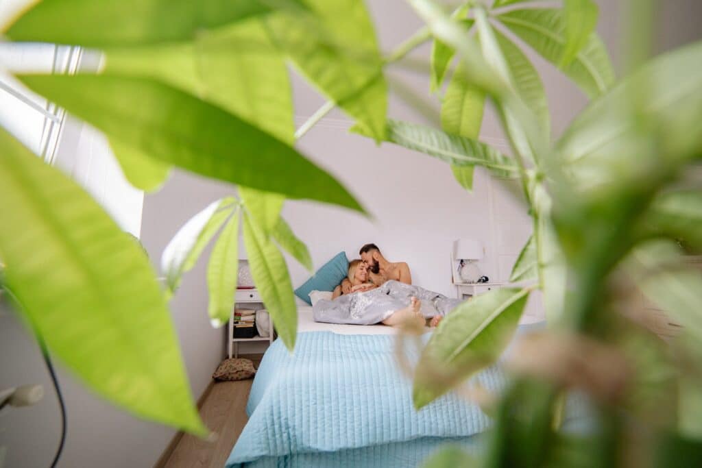 Young Hugging Couple Lying in Bed 