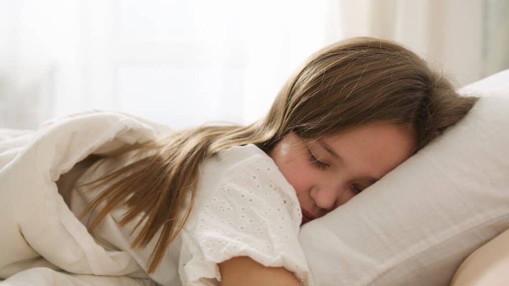 A Woman Lying on Front in Bed